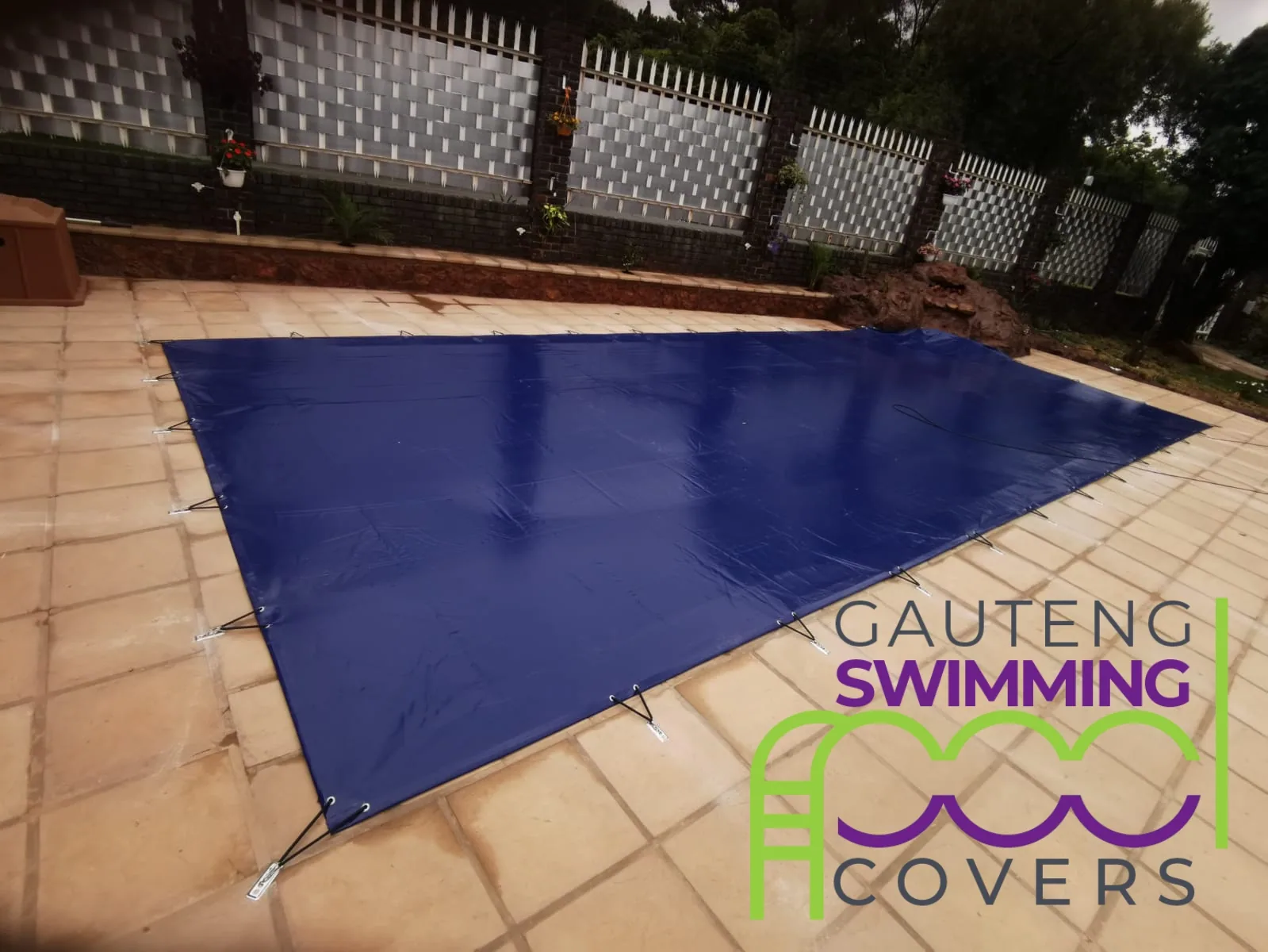 Blue solid PVC cover secured with hooks and plates